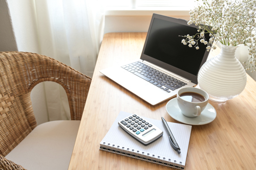 Laptop and calcualor arranged neatly on desk